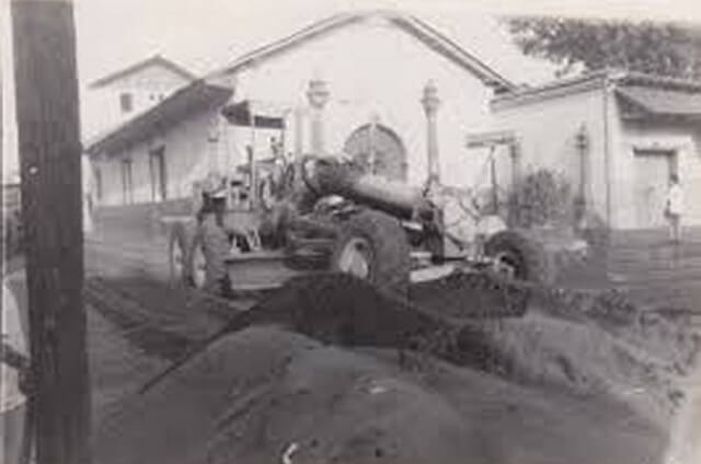 A loader cleaning the street in front of San Juan de Dios Church that was full of ashes after 1992 eruption.  