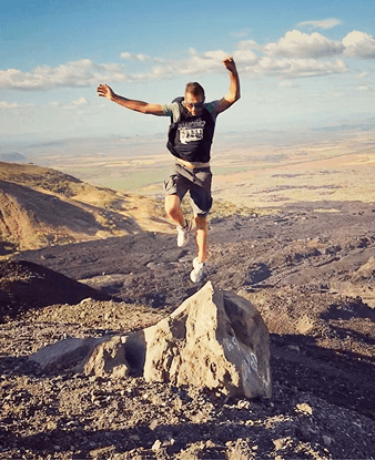 Man jumping on top of Cerro Negro Volcano in Nicaragua
