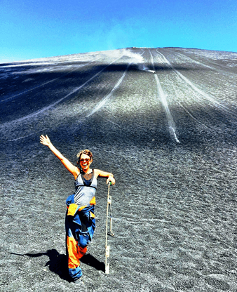 Volcano Boarder holding her board at the slopes of Cerro Negro Volcano