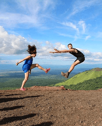 Girls jumping on top of Cerro Negro Volcano in Nicaragua